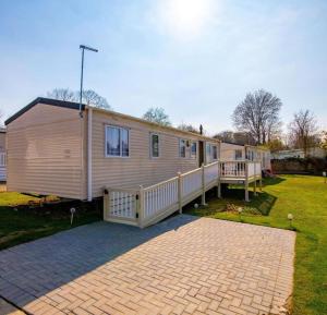 a mobile home with a porch and a deck at VAL233 - 4B - Coghurst Park in Westfield