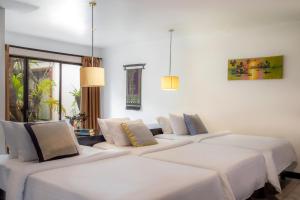 Postel nebo postele na pokoji v ubytování Bunwin Siem Reap