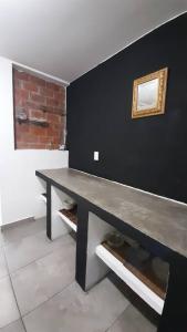 a black room with a table and a mirror on the wall at Hospedaje Feria de San marcos 2024 Para 8 Personas in Aguascalientes