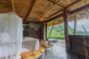 a bedroom with a bed with a mosquito net at Shigar Livin Bali in Sidemen