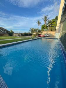 a large blue swimming pool next to a building at Contry Mar Caraballeda in Caraballeda