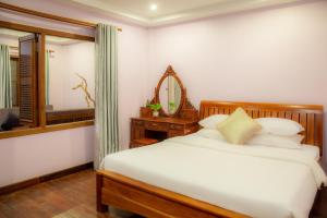 Postel nebo postele na pokoji v ubytování Bunwin Siem Reap