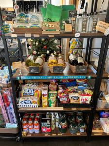 a store shelf filled with lots of food and a christmas tree at Boiboi Camp site Surrounded by Japanese Nature in Taketa