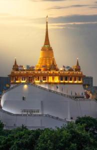 a large building with a golden roof with a tower at Victory place 2 (Golden Mount) in Bangkok