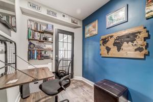 a home office with blue walls and a wooden desk at TheWrightStays Art Haven at Fairlawn Gardens in Washington, D.C.
