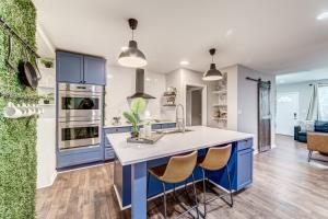 a kitchen with blue cabinets and white counter tops at TheWrightStays Art Haven at Fairlawn Gardens in Washington