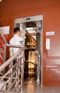 a man standing inside of a door in a building at Thảo Nguyên Hotel in Vinh