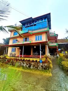 a building with a sign on the side of it at Pauwa Garden Resort in Nagarkot