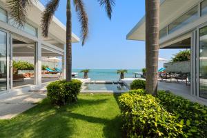 an exterior view of a house with a view of the ocean at Villa Playa Samui in Choeng Mon Beach