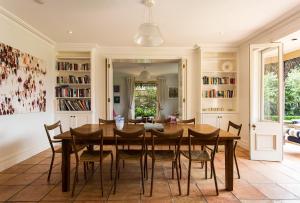 a dining room with a wooden table and chairs at Victorian Masterpiece in Sydney