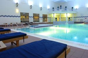 a room with a pool, chairs, and a pool table at Belton Woods Hotel, Spa & Golf Resort in Grantham