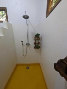 a bathroom with a shower in the corner of a room at Kivulini Lodge in Utende