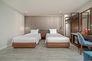 Postel nebo postele na pokoji v ubytování Lupin Boutique Hotel Danang