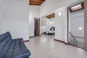 a living room with a blue couch and a staircase at MEDELLIN- Cerca al Poblado-401 in Medellín