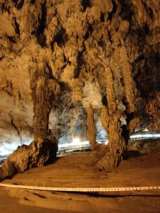 a tunnel in a cave with a wooden walkway at Triệu Chương Homestay in Cao Bằng