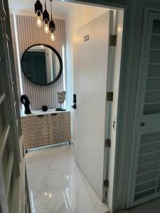 um corredor com um espelho e um corredor branco com um espelho em Best Place Cayenas 7 em La Grúa
