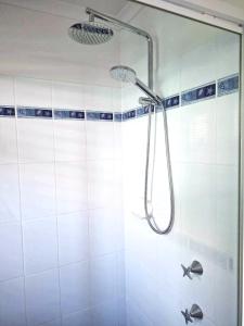a shower with a shower head in a bathroom at Central Studio Accommodation in Gladstone