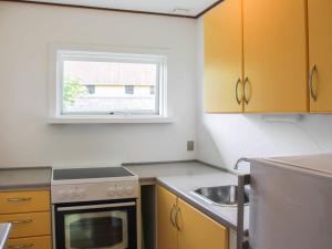 A kitchen or kitchenette at 4 person holiday home in Svaneke