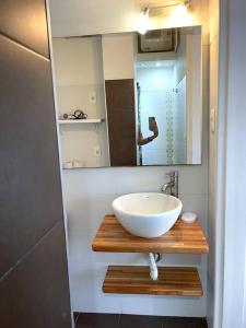 a bathroom with a bowl sink and a mirror at Home Sweet a mts Plaza Independencia in Montevideo