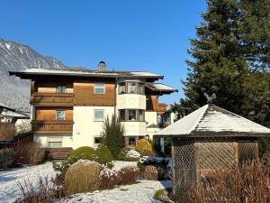 a large house with snow in front of it at Haus Gerlinde Schernthaner in Langkampfen