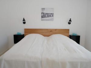 a bed with a white comforter in a room at 4 person holiday home in Allinge in Allinge