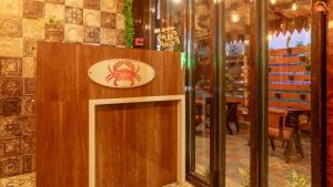 a restaurant with a sign on a wooden wall at Hotel Atlanta - A Seaview Hotel in Port Blair