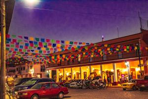 a building with a bunch of colorful flags hanging from it at Copa de Oro Hotel Boutique in Mascota