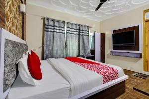 Una cama o camas en una habitación de OYO Lilly Resort