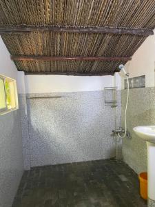 a bathroom with a shower and a sink at Thuy - Gunter Garden Bungalow in Mui Ne