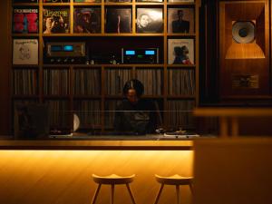 a man sitting at a counter in a bar at Kaname Inn Tatemachi in Kanazawa