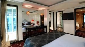 a bedroom with a bed and a desk and a living room at Super Nile Cruise LUXOR & ASWAN in Luxor