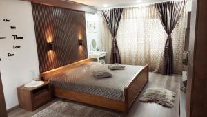 a bedroom with a large bed in a room at Cuza 21 in Brăila