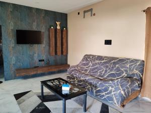 a living room with a couch and a table at Lavish inn homestay in Mysore