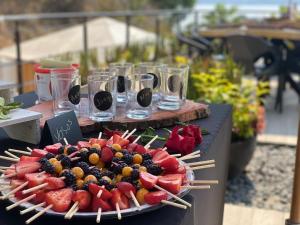 a plate of fruit on a table with chop sticks at Airam, Holistic Boutique Hotel in Tequesquitengo