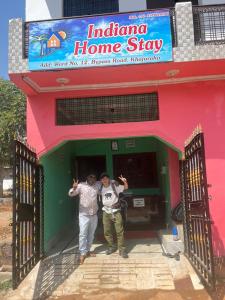 two men standing in the doorway of a building at Indiana home stay in Khajurāho