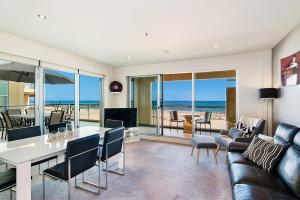 a living room with a view of the ocean at Glenelg Beachfront Luxury Apartment in Glenelg