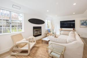 a living room with a couch and a fireplace at Seaside Home Modern Retreat with Breathtaking Views and Beachside Charm in Half Moon Bay