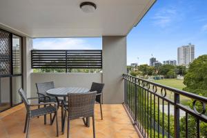 a patio with a table and chairs on a balcony at Comfy 2-Bedroom Family Apartment with Free Parking in Brisbane