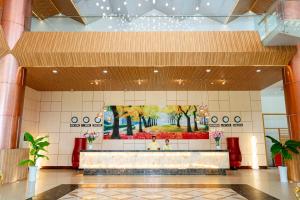 a lobby with a large painting on the wall at Ocean Waves Resort Cam Ranh in Cam Lâm