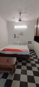 A bed or beds in a room at CGR PONDY