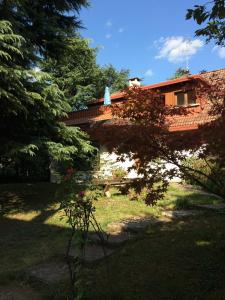 a house in a yard with trees in front of it at App Carolina in Creazzo
