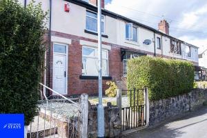 a brick house with a white door on a street at 2ndHomeStays-3 Bedroom House - Sleeps 6 - City Centre -Stoke-on-Trent in Stoke on Trent