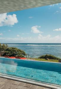 a swimming pool with a view of the ocean at Villa Arty by muse villas in Poste Lafayette