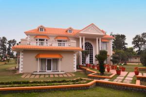 a large house with an orange roof at Green Orchid Farms I Swimming Pool I Wedding I party I 87oo2o5865 in Gurgaon