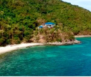 a house on a small island in the ocean at ISLA tress Bonita Wellness Escape Island in San Vicente