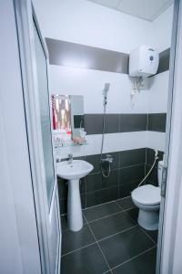 a bathroom with a sink and a toilet at OPA HOTEL HUE in Hue