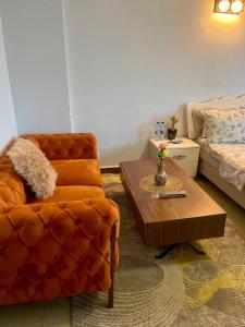 a living room with a chair and a coffee table at Arrabella Ocean View Home in Dar es Salaam