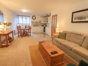 a living room with a couch and a table at River Walk in Kendal