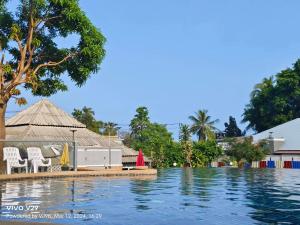 a view of a pool with chairs and trees at Siri Maya Garden Home Samui in Koh Samui 