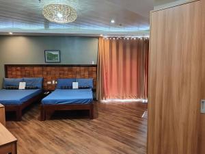 a hotel room with two beds and a window at Norlu Cedec Midpoint Hotel in Rosario